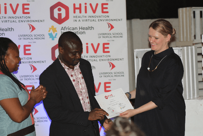 Certificate presentation at graduation ceremony of LSTM HiVE project supported by African Health Innovatio Centre in Accra, Ghana